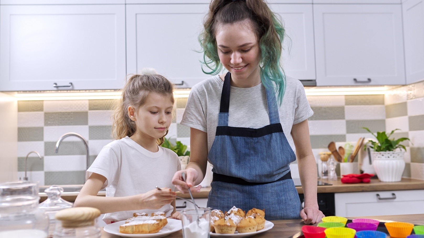 kids-sprinkling-decorating-cakes-with-white-sugar-2022-01-13-23-22-09-utc