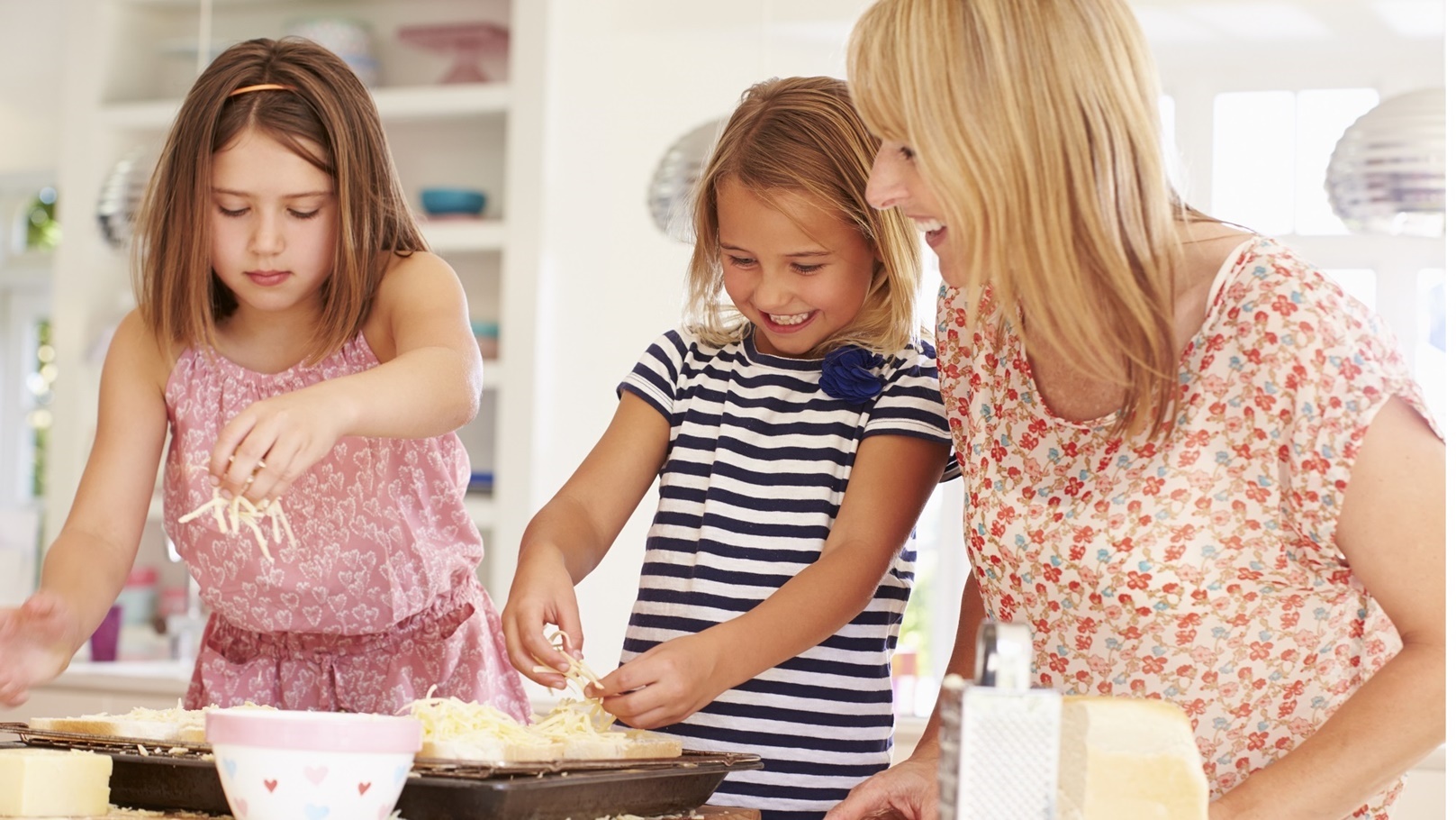 girls-with-mother-making-cheese-on-toast-2021-08-26-16-12-46-utc