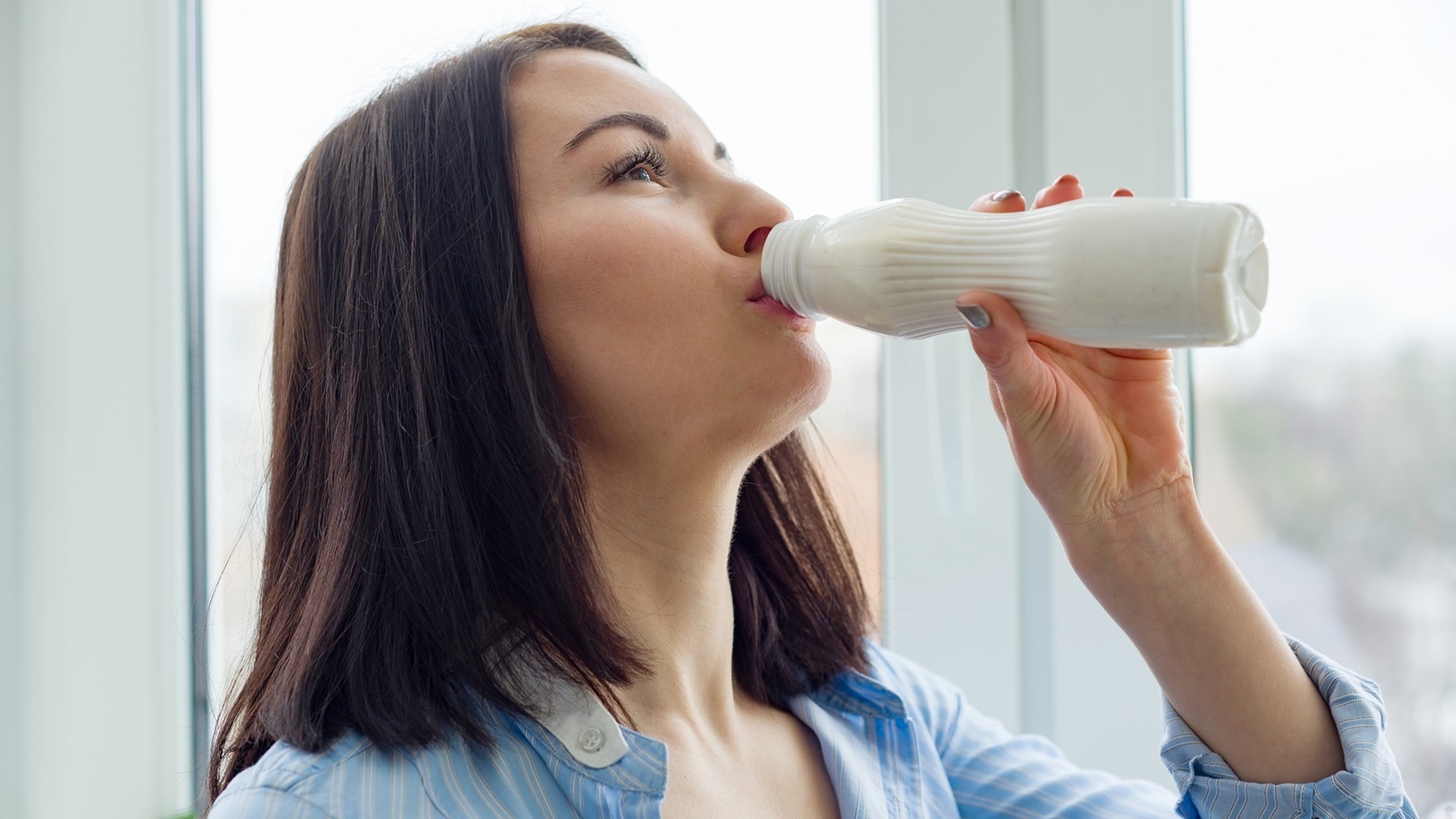 young-beautiful-woman-with-bottle-of-milk-yogurt-2022-03-16-22-13-45-utc