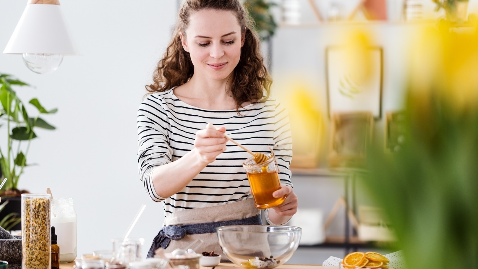 smiling-woman-pouring-honey-2021-08-26-15-45-24-utc