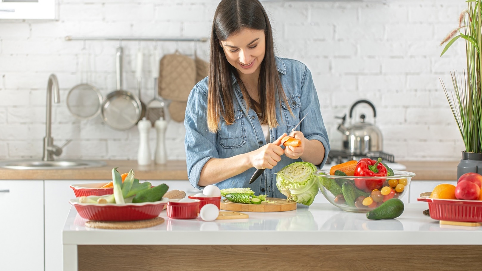 a-young-woman-is-preparing-a-salad-in-the-kitchen-2021-09-02-08-00-19-utc