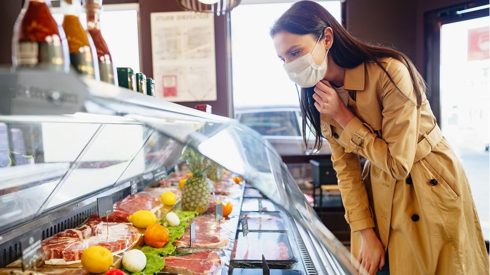 happy-young-woman-in-face-mask-choosing-meat-from-2022-03-05-20-22-02-utc
