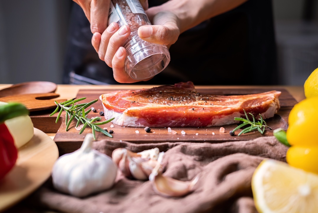 chef-prepares-pork-chop-steak-with-barbecue-sauce-2021-10-06-09-52-48-utc
