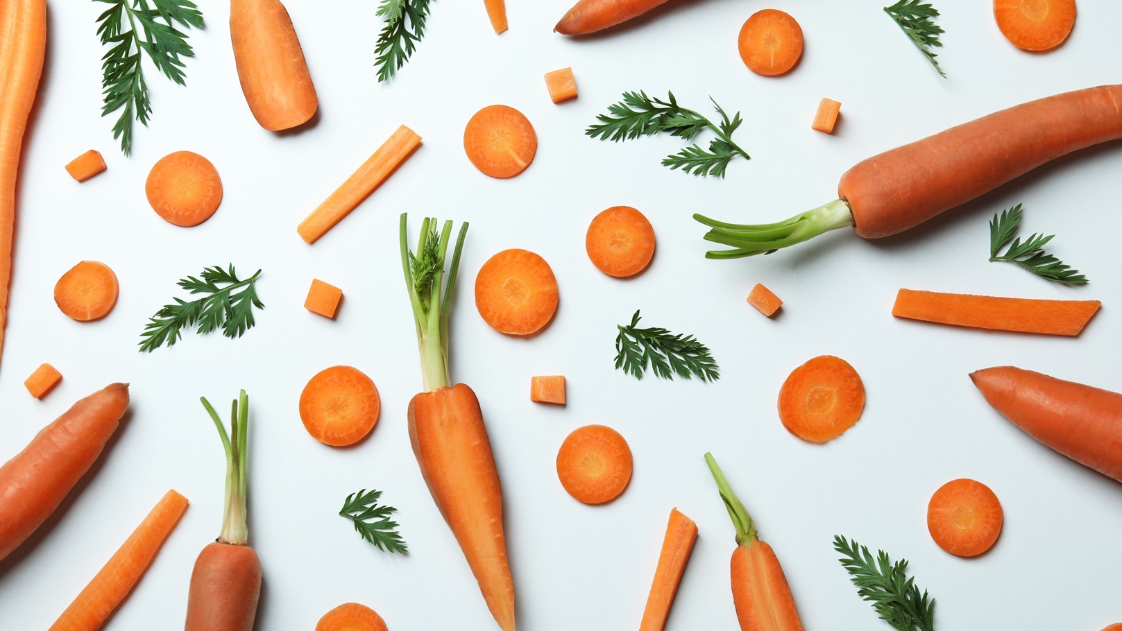 carrots-slices-and-leaves-of-carrot-on-white-back-2021-09-02-06-35-31-utc