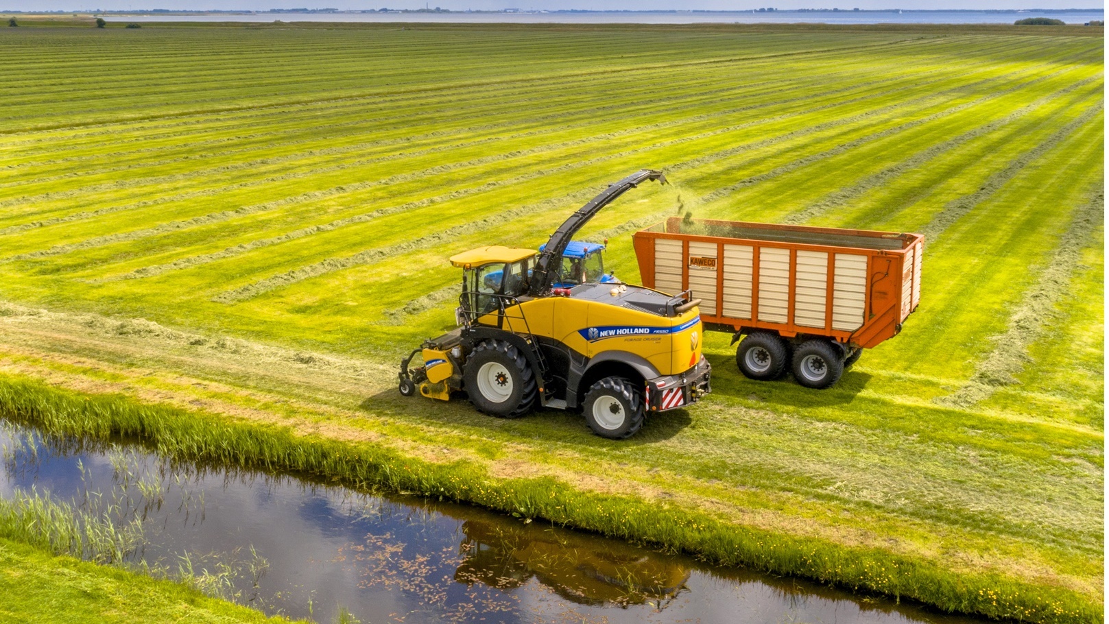 tractors-on-fresh-mowed-green-agricultural-grassla-2021-09-02-23-25-53-utc