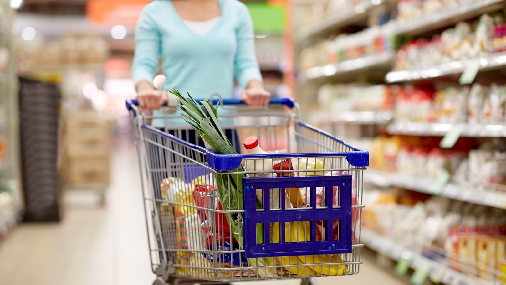 woman-with-food-in-shopping-cart-at-supermarket-2021-08-26-22-52-42-utc