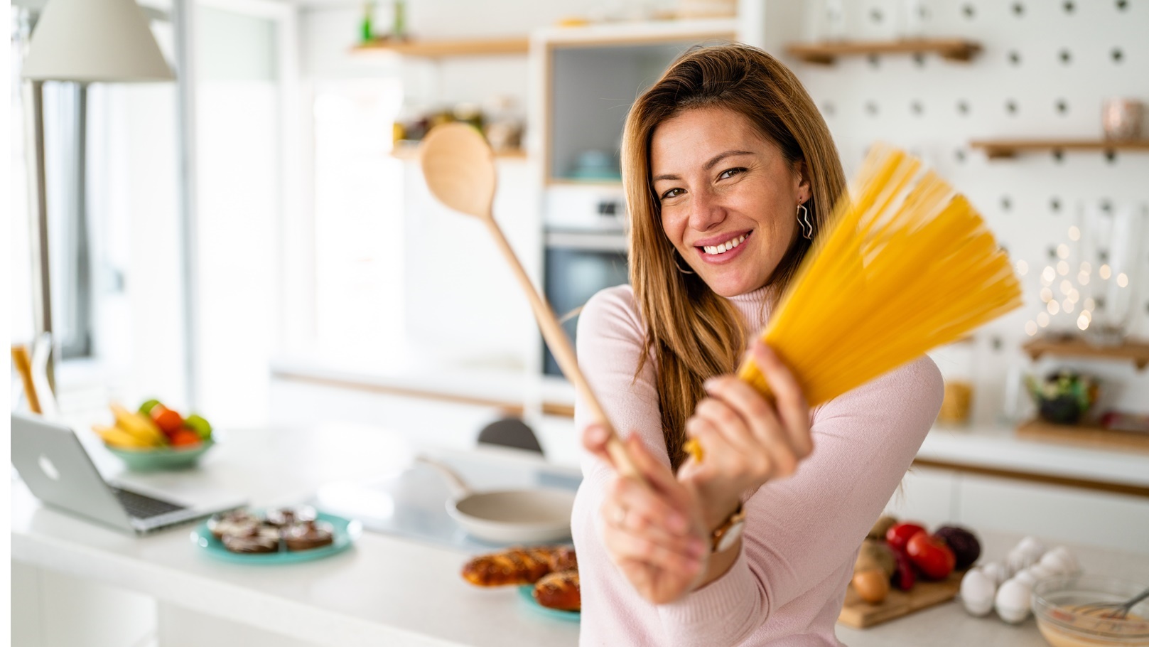 portrait-of-beautiful-woman-with-pasta-at-her-kitc-2021-09-02-06-27-38-utc