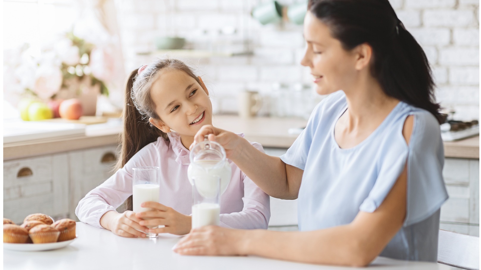 mother-and-daughter-drinking-milk-in-kitchen-toget-2021-08-26-16-33-38-utc