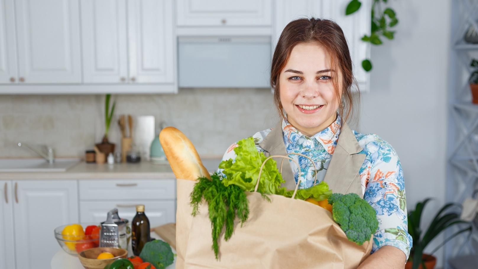 smiling-woman-in-the-kitchen-with-a-bag-of-groceri-2021-08-26-17-11-02-utc