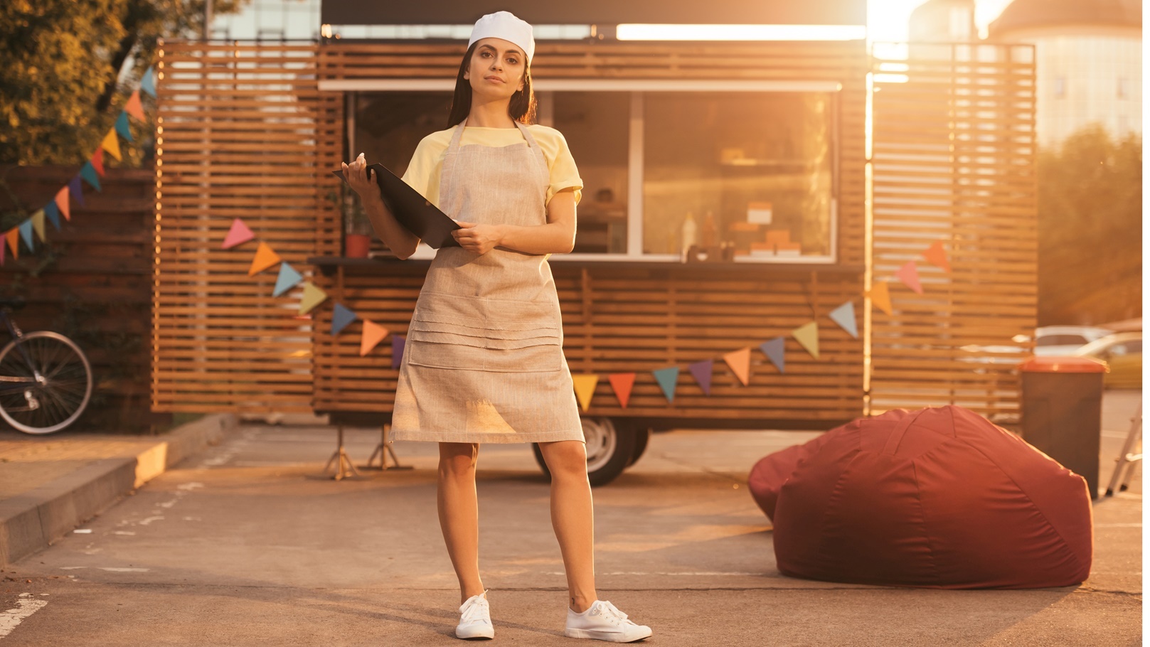 attractive-chef-in-apron-holding-clipboard-near-fo-2021-10-14-21-34-25-utc