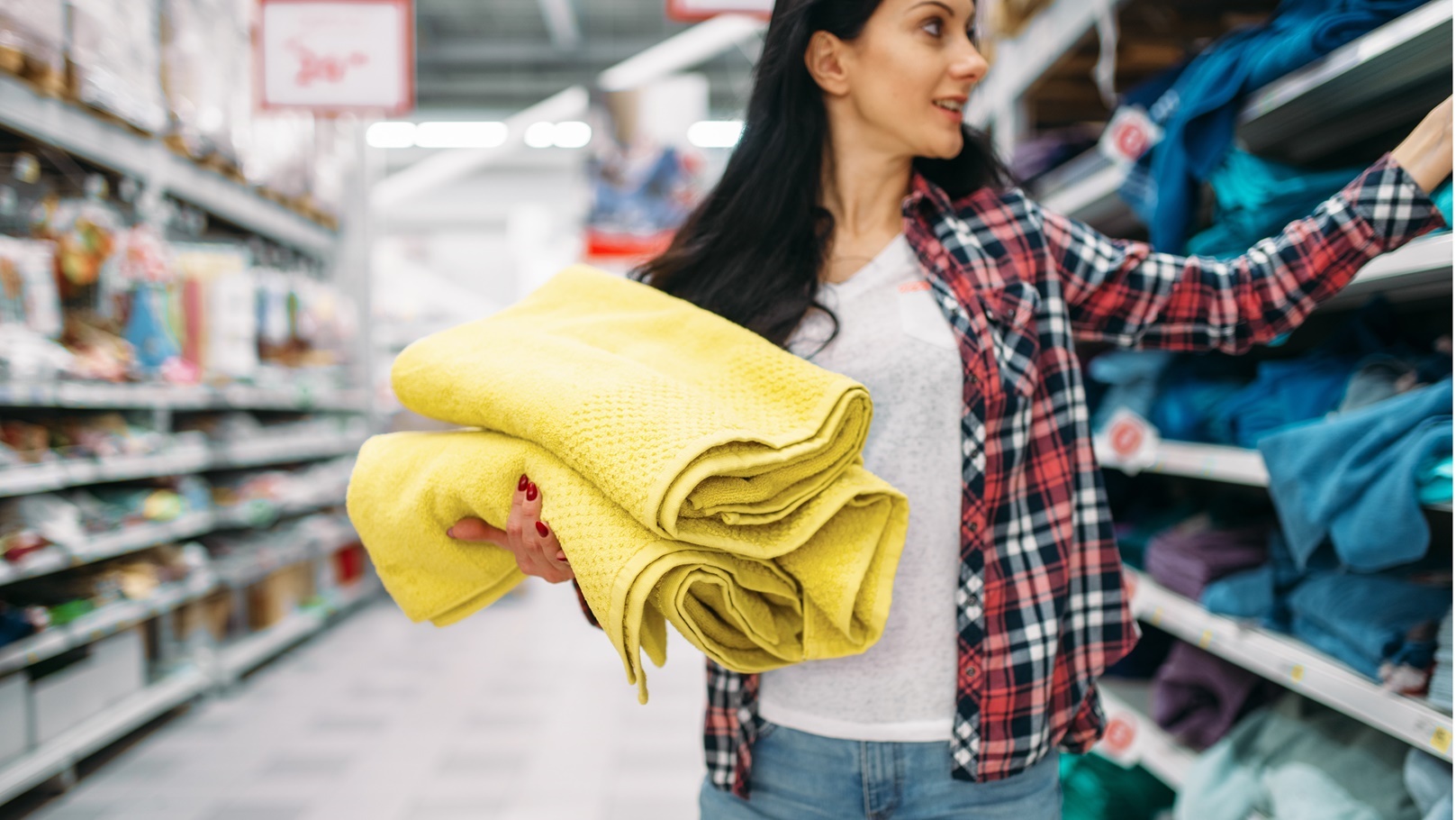 young-woman-buying-towels-in-supermarket-2021-08-26-16-26-51-utc