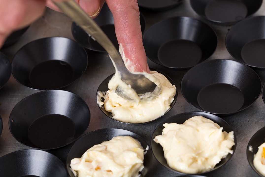 taking-muffin-dough-to-baking-pan-2021-08-26-15-35-58-utc