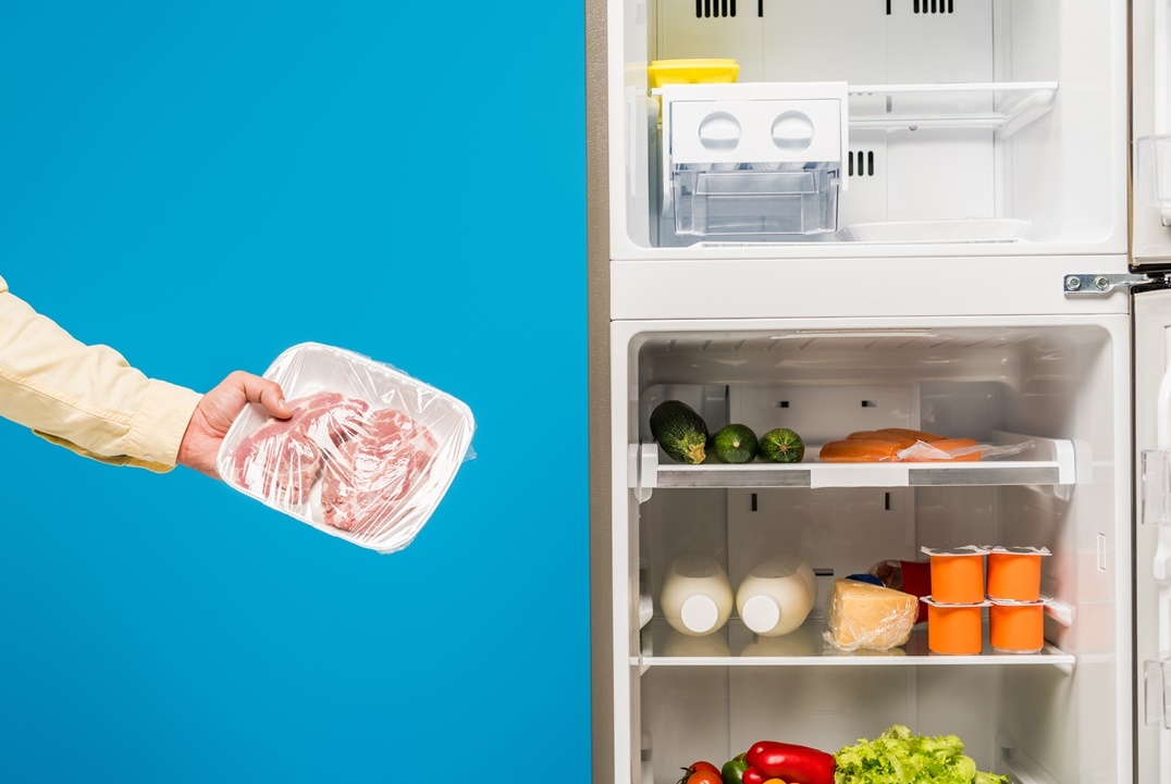 cropped-view-of-man-holding-frozen-meat-near-open-2021-09-03-01-48-39-utc