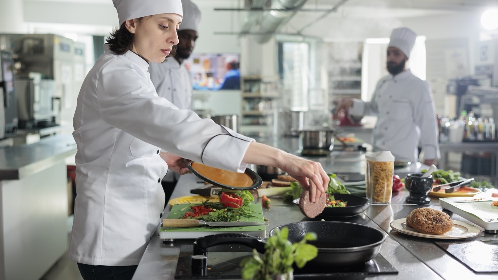 food-industry-worker-cooking-beef-patty-in-pan-whi-2022-03-30-14-51-31-utc