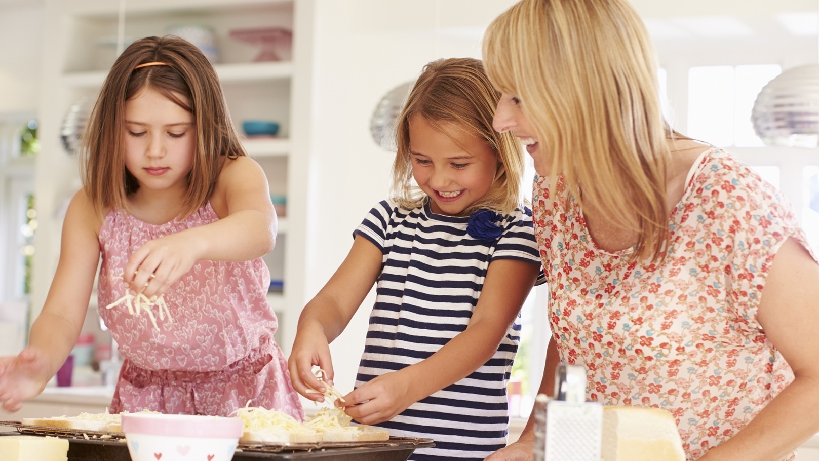 girls-with-mother-making-cheese-on-toast-2021-08-26-16-12-46-utc