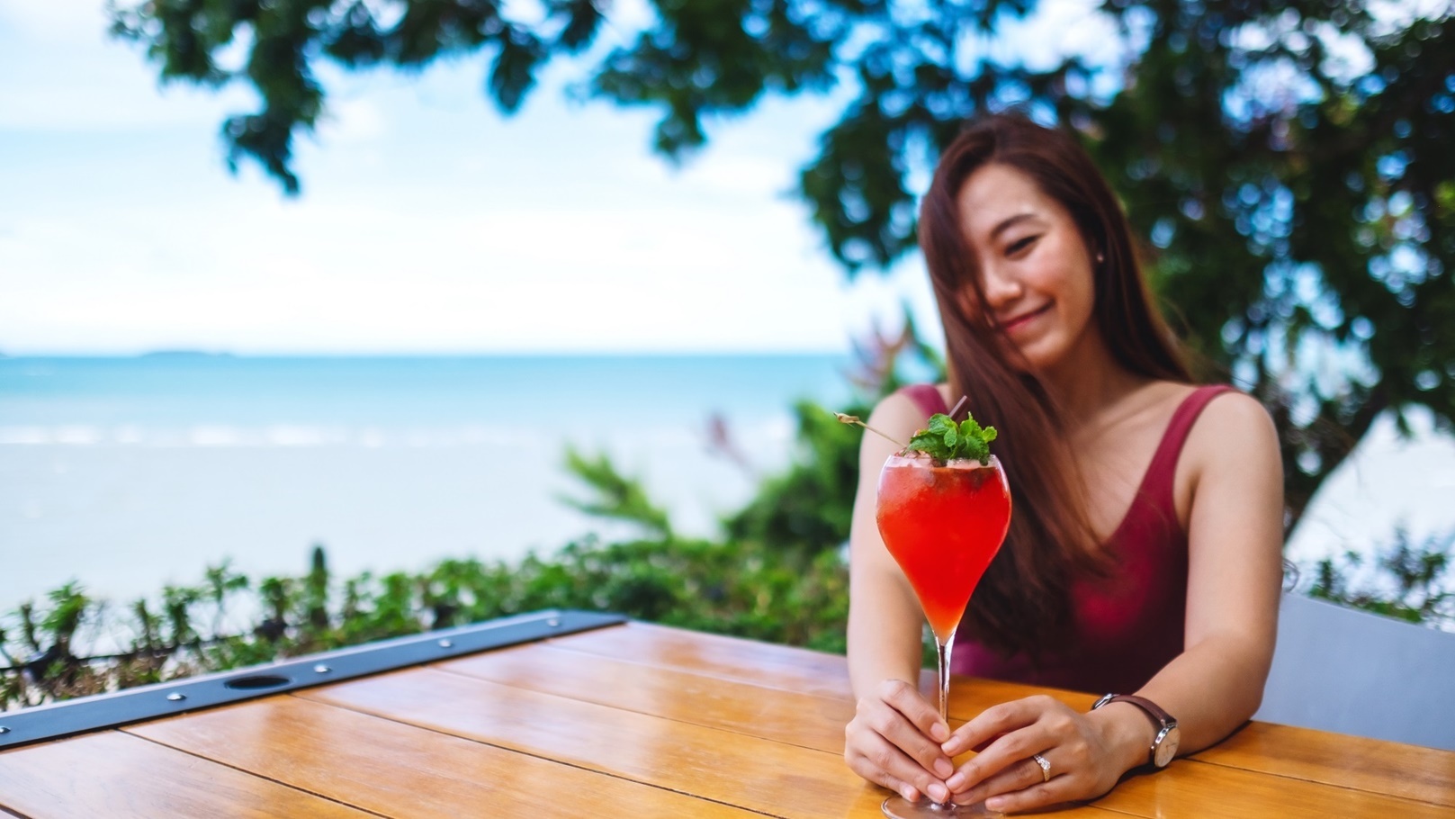 a-beautiful-young-asian-woman-drinking-cocktail-i-2021-10-21-03-26-32-utc