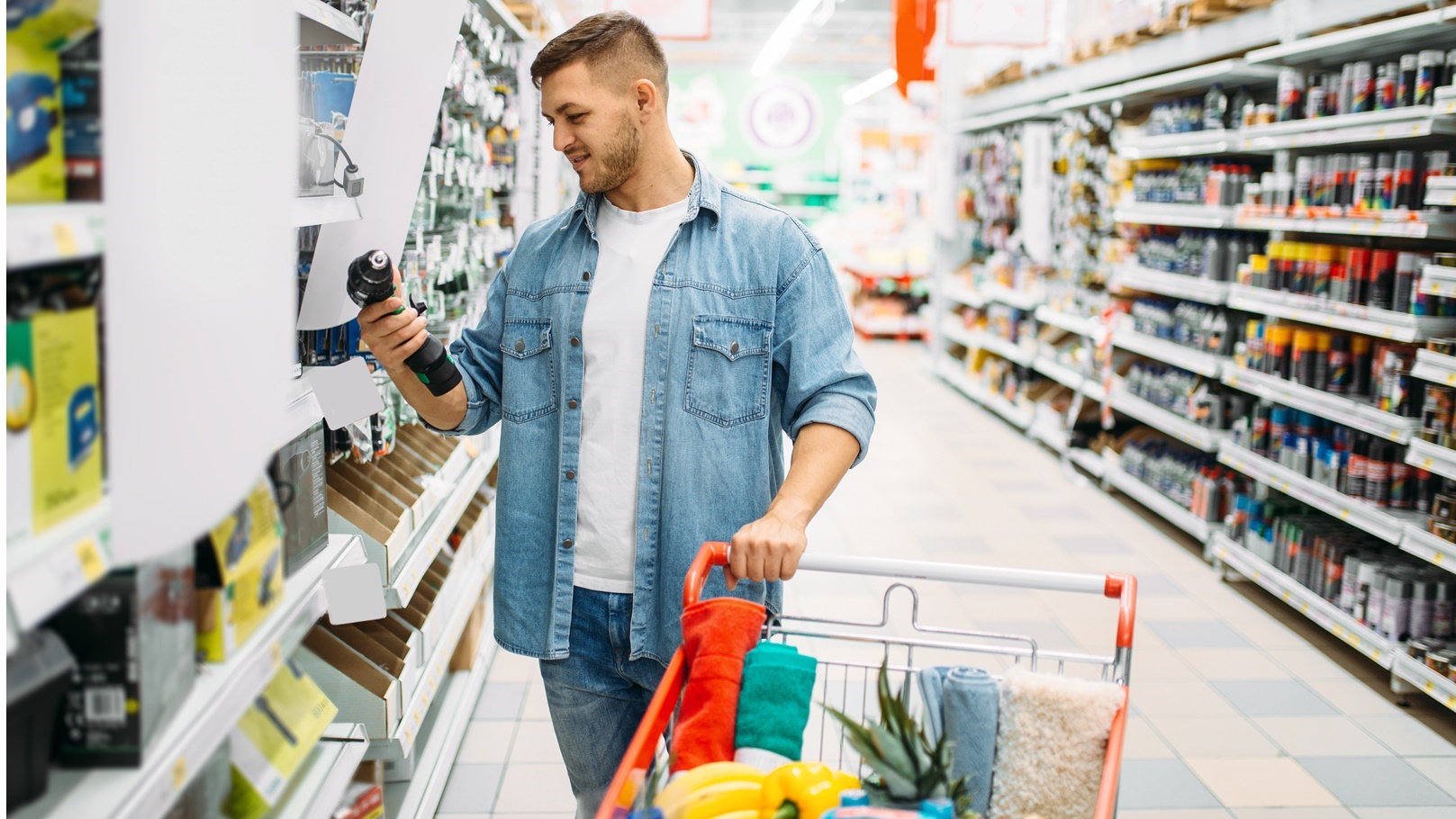 man-choosing-electric-screwdriver-in-supermarket-2021-08-26-16-26-59-utc