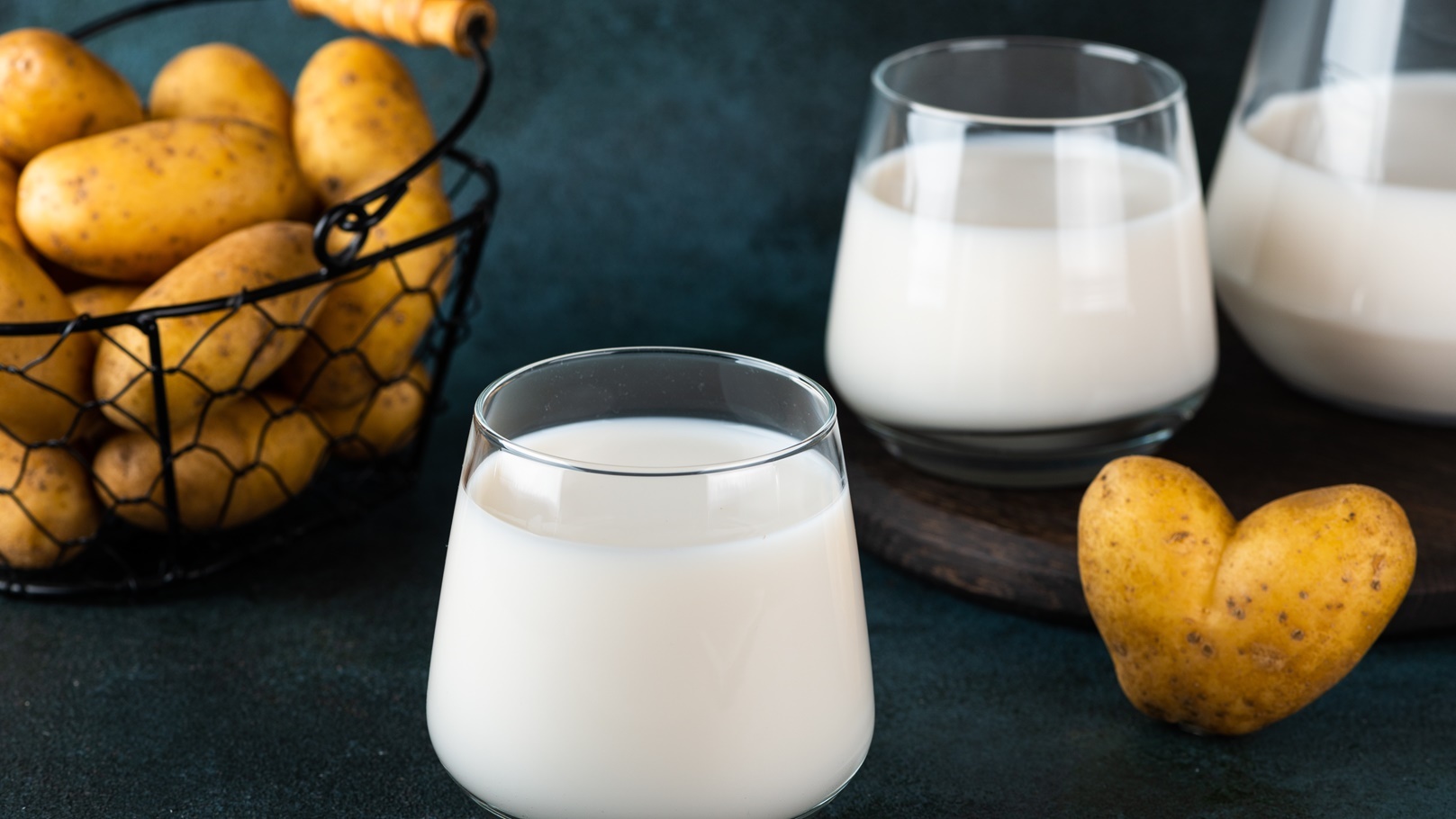 pouring-vegan-potato-milk-in-glass-and-potato-in-b-2022-02-10-00-11-16-utc