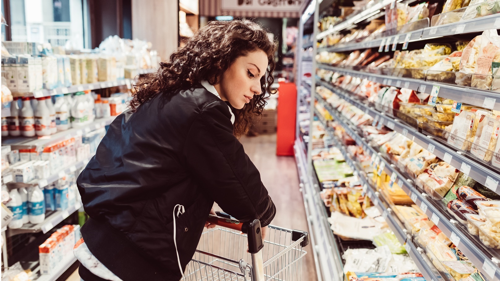 woman-pushing-shopping-cart-at-supermarket-2022-02-03-15-56-39-utc
