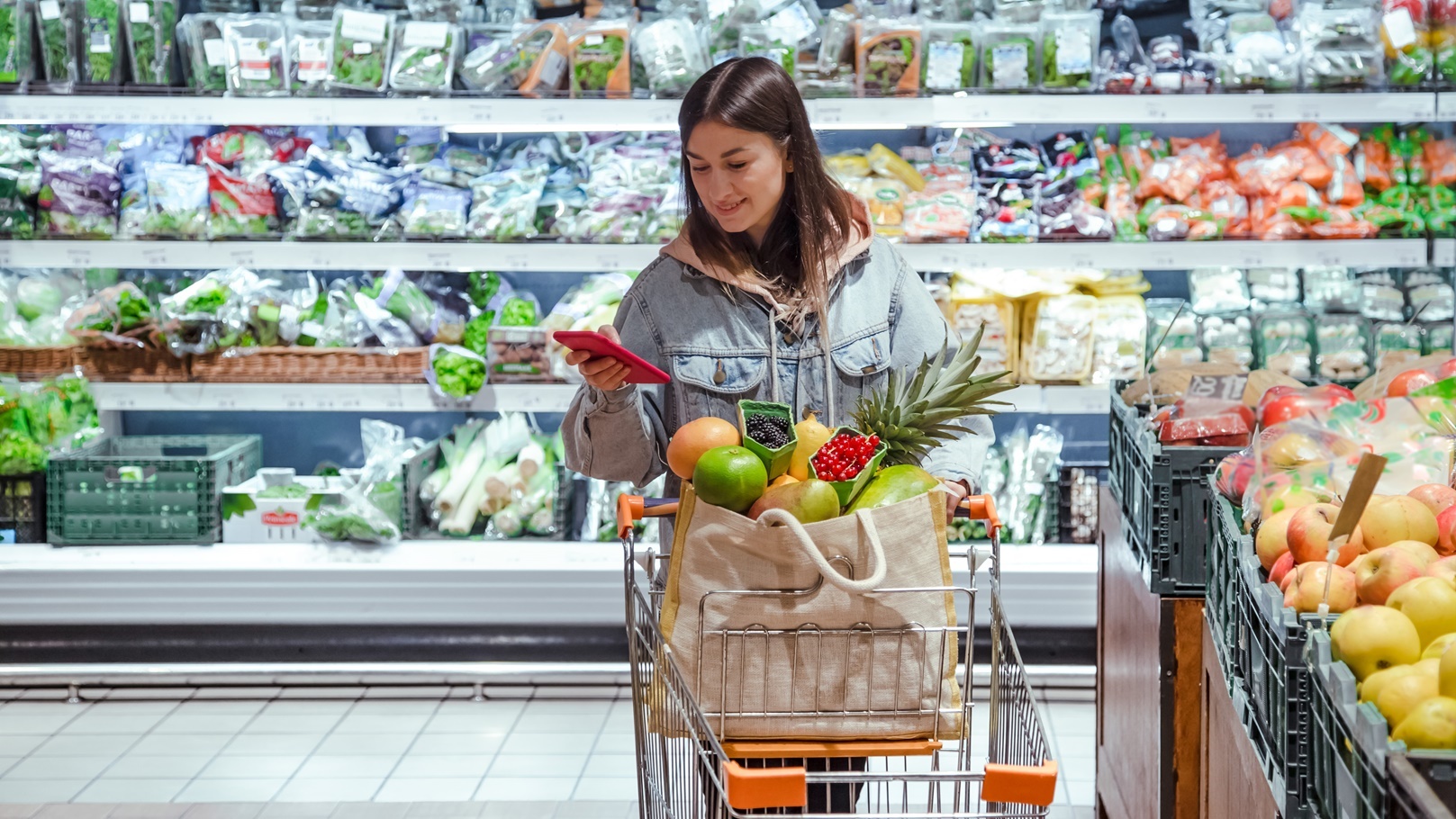 a-young-woman-buys-groceries-in-a-supermarket-with-2022-02-07-07-55-23-utc