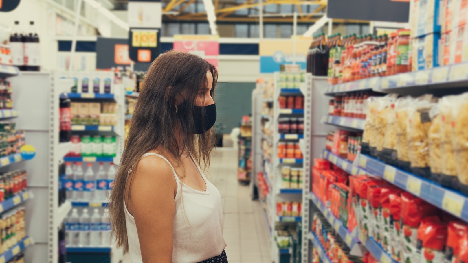 girl-with-a-face-mask-buying-items-at-the-supermar-2022-01-28-12-33-47-utc