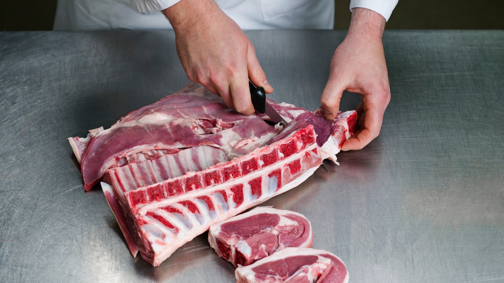 butcher-cutting-meat-in-butcher-shop-2021-08-26-22-34-30-utc