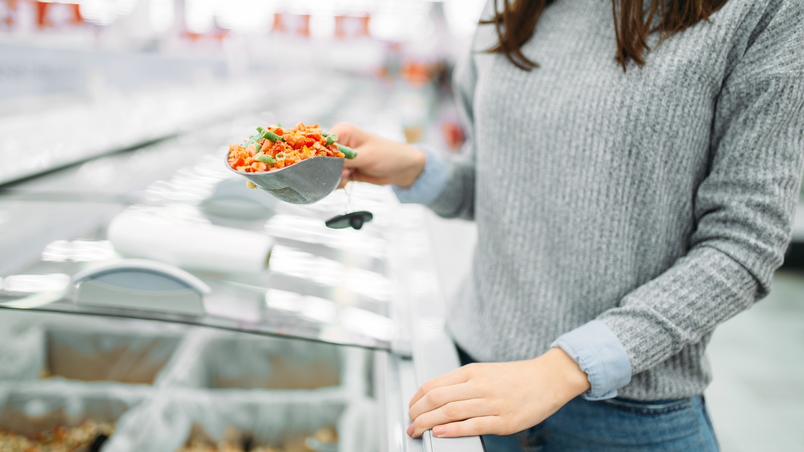 woman-picks-up-package-of-frozen-vegetables-2021-08-26-16-26-58-utc