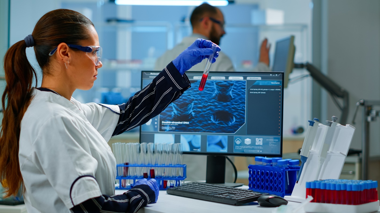 scientist-doctor-looking-at-blood-sample-and-writi-2021-08-30-17-43-49-utc