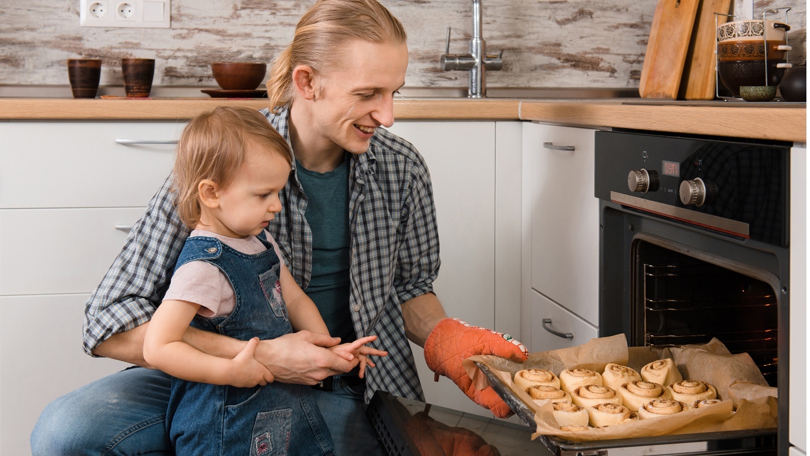 father-and-kid-waiting-for-freshly-baked-buns-brea-2021-12-22-17-57-17-utc