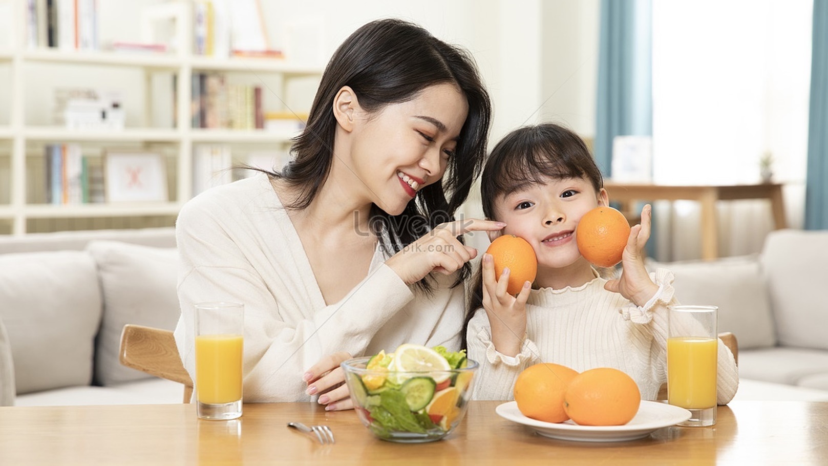 lovepik-mother-and-daughter-eating-fruit-together-picture_501567401