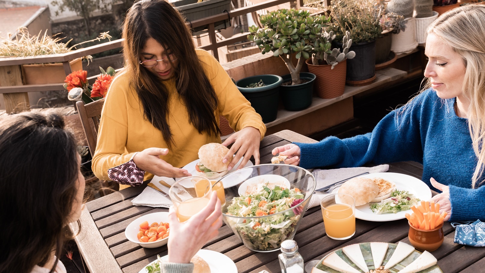 happy-multiracial-friends-eating-breakfast-in-rest-2021-09-03-22-28-13-utc