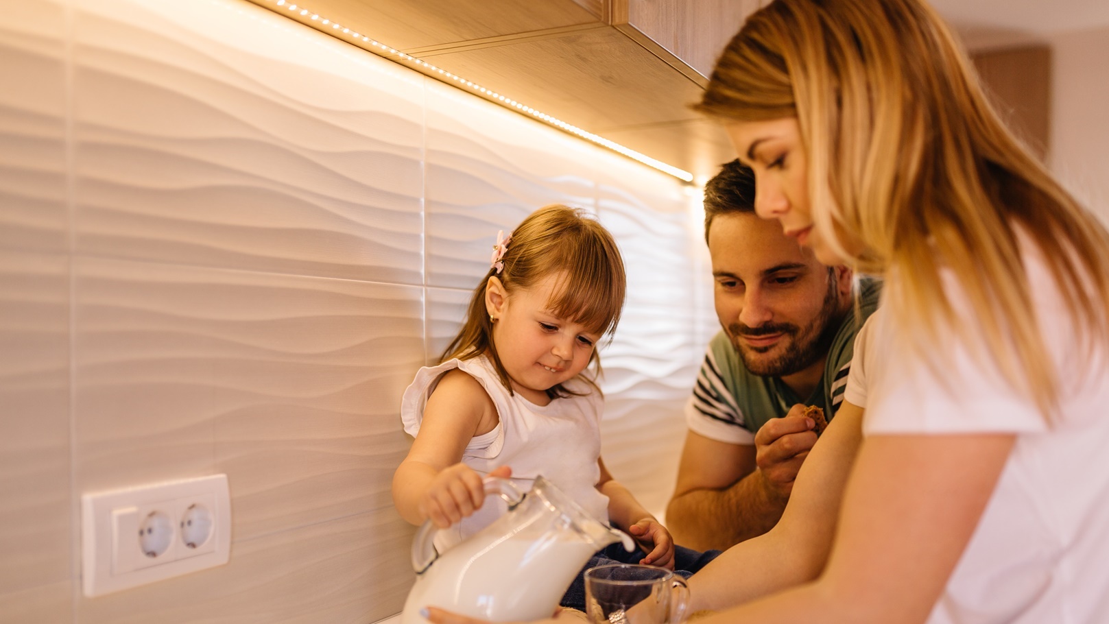 little-girl-is-in-kitchen-with-her-parents-and-dri-2021-09-01-02-09-30-utc