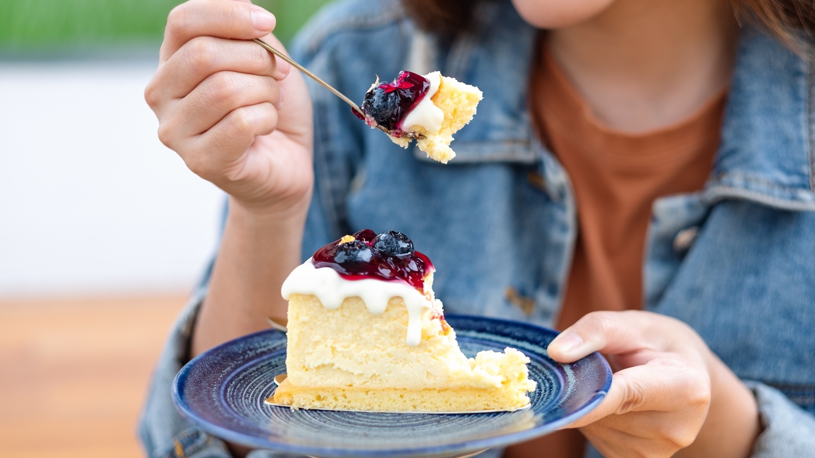 closeup-image-of-a-young-woman-eating-blueberry-ch-2021-10-21-03-27-59-utc