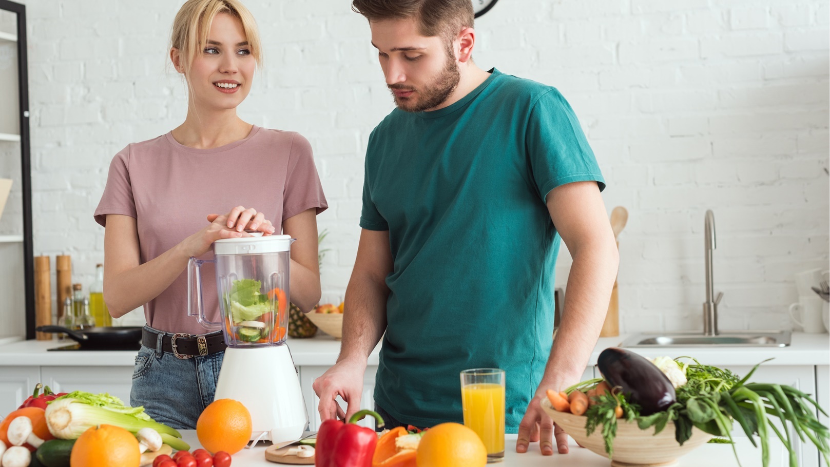 couple-of-vegans-preparing-vegetable-juice-with-ju-2021-09-03-05-16-59-utc