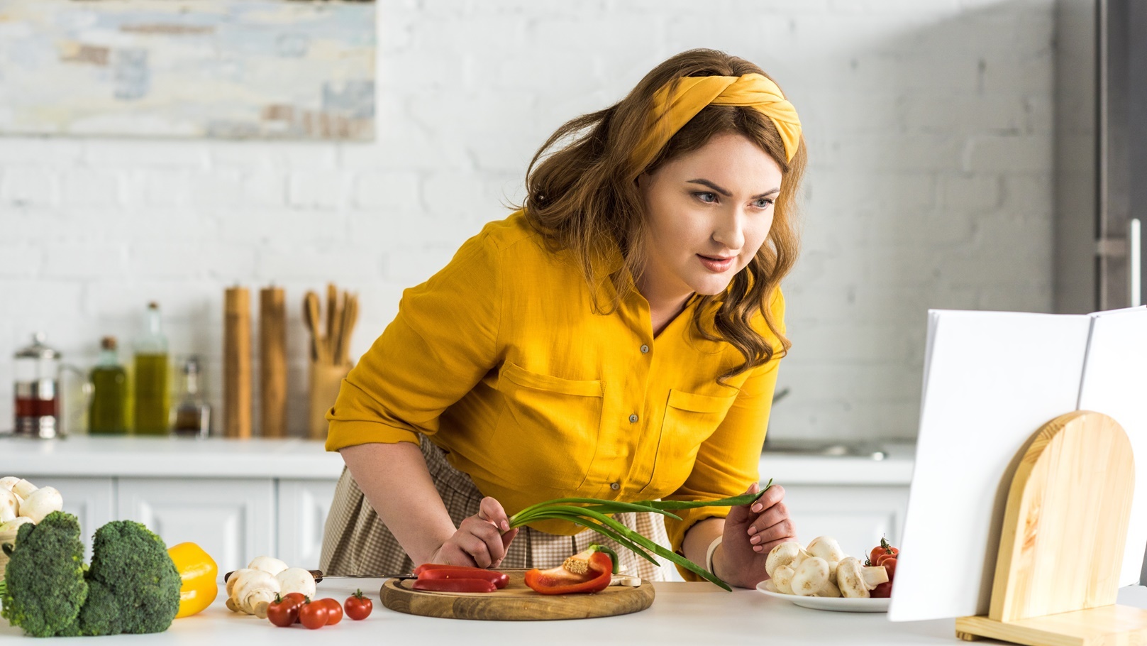 beautiful-woman-reading-recipe-in-recipe-book-at-k-2021-09-03-05-16-09-utc