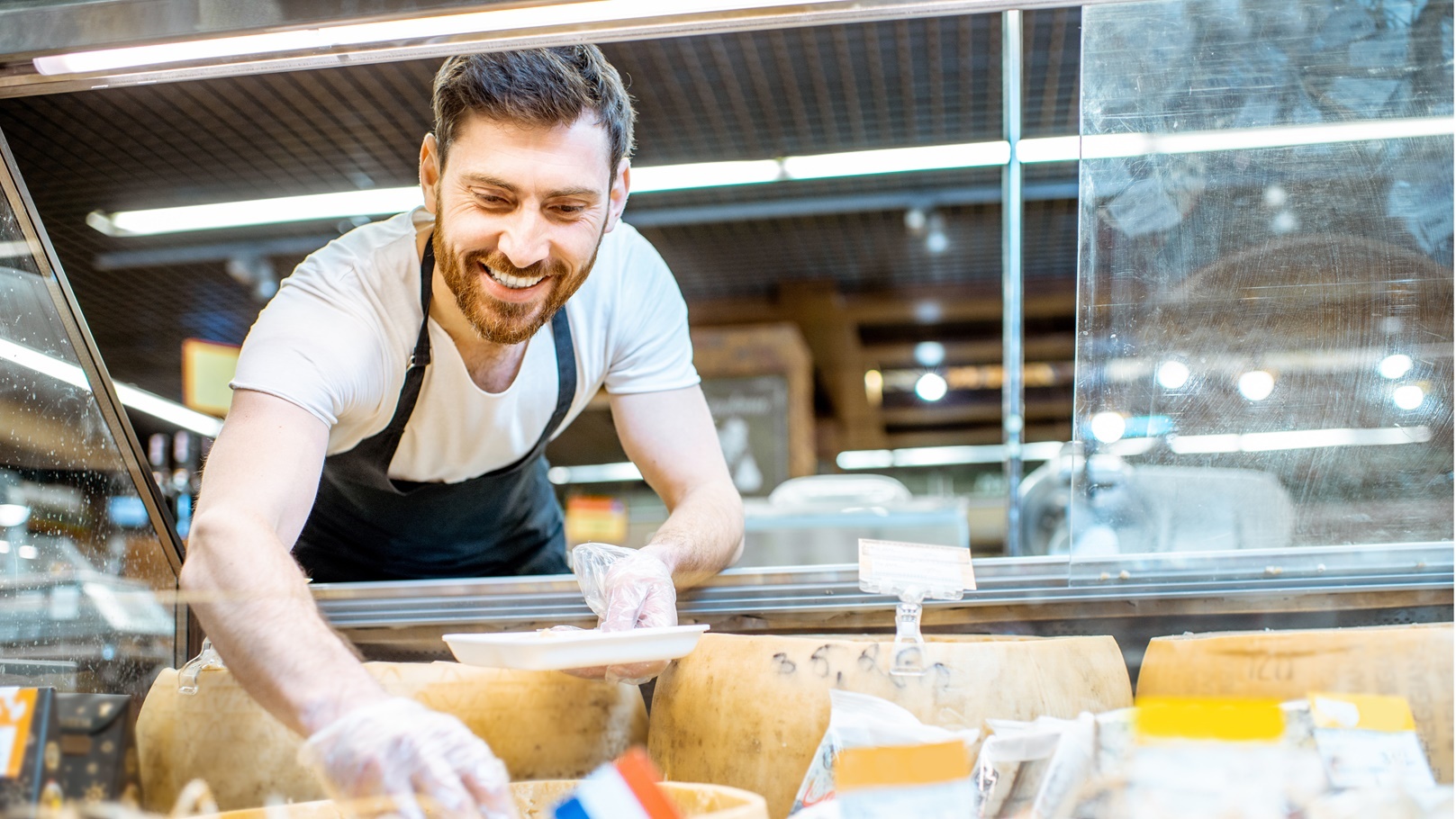 man-packing-cheese-in-the-shop-2021-11-02-01-36-34-utc