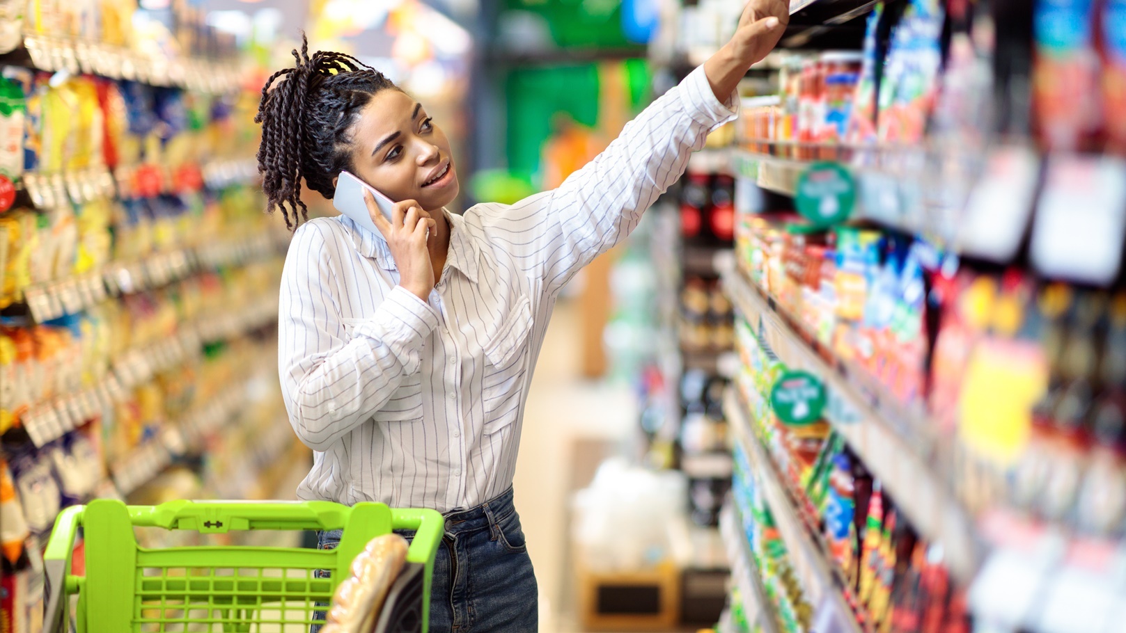 african-woman-talking-on-mobile-phone-buying-food-2021-09-01-16-39-12-utc