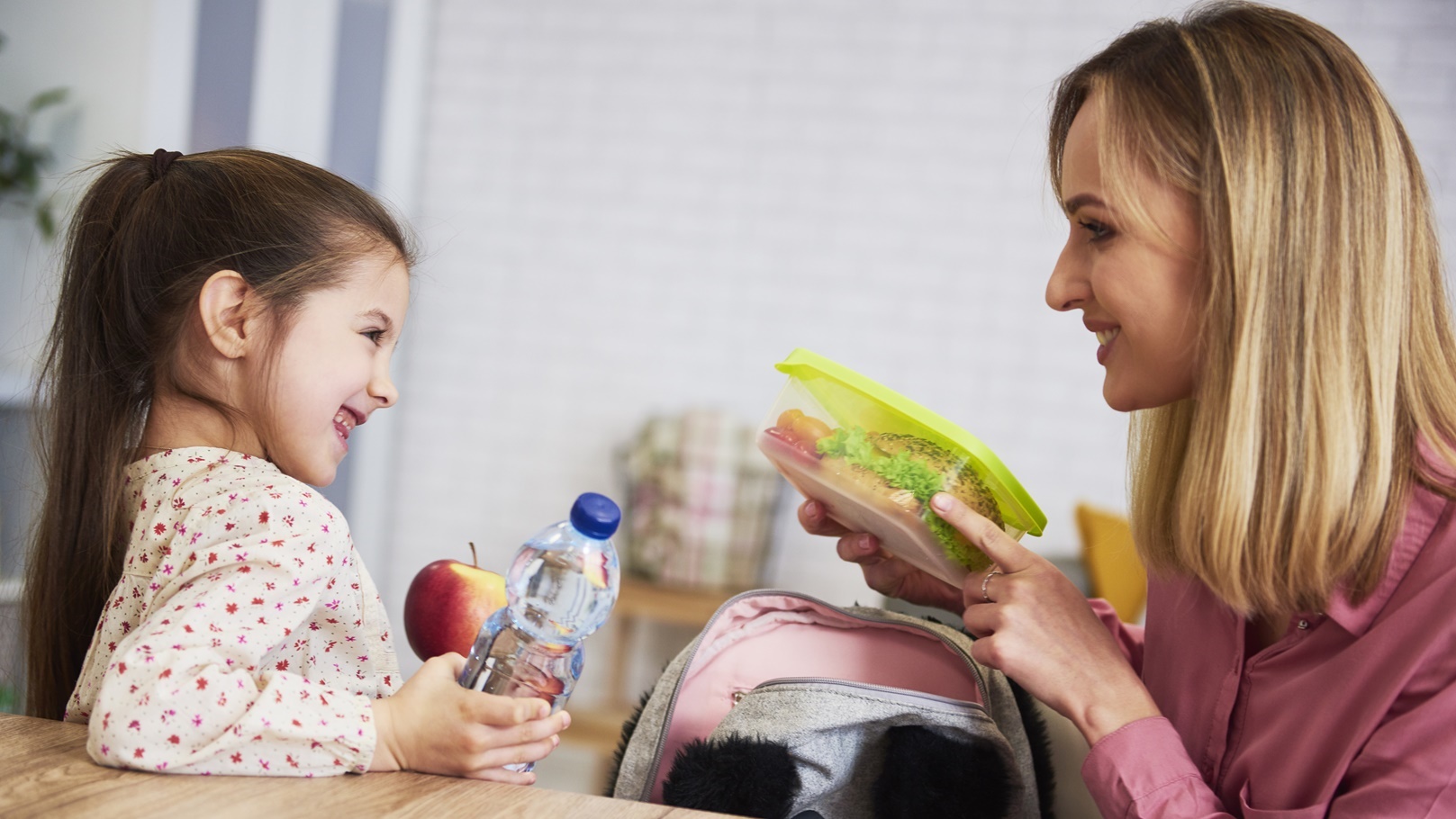 mum-putting-lunch-box-with-healthy-food-in-backpac-2021-08-30-02-23-27-utc