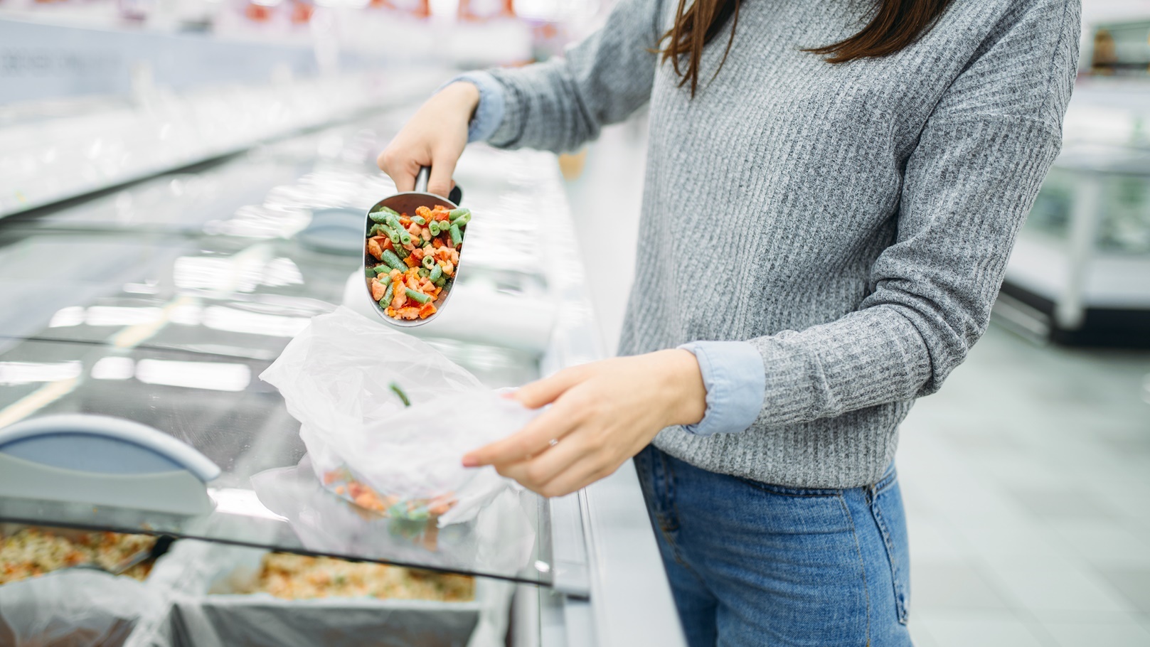 woman-picks-up-package-of-frozen-vegetables-2021-08-26-16-26-17-utc (1)
