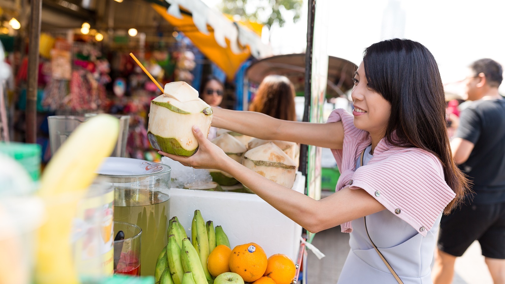 woman-buying-coconut-drink-in-weekend-market-2021-08-30-01-48-09-utc