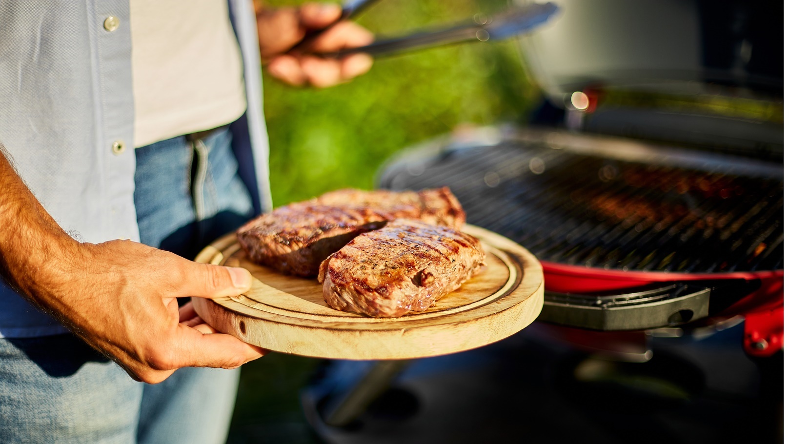 man-put-down-meat-on-a-wooden-board-ready-to-eat-g-2021-11-08-17-40-22-utc