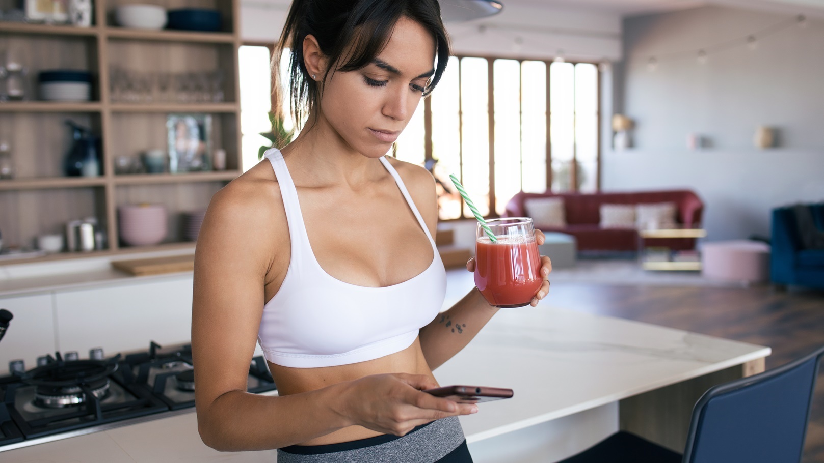 sporty-young-woman-using-her-mobile-phone-while-dr-2021-08-27-09-34-33-utc