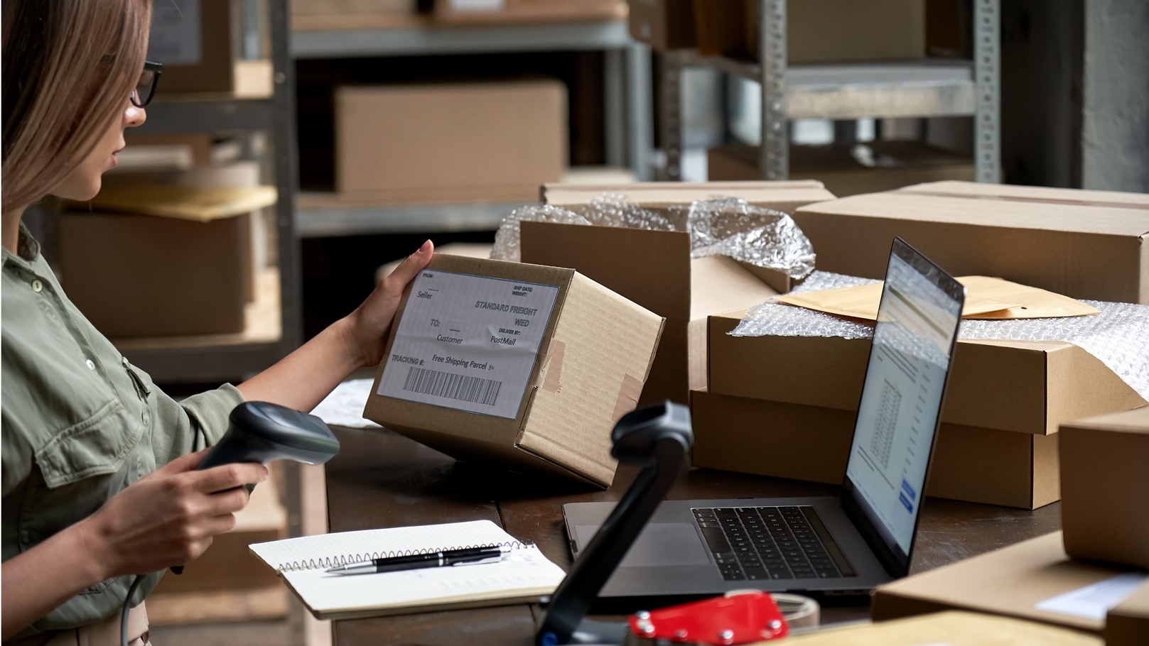female-seller-scanning-ecommerce-shipping-box-in-d-2021-09-02-07-22-46-utc
