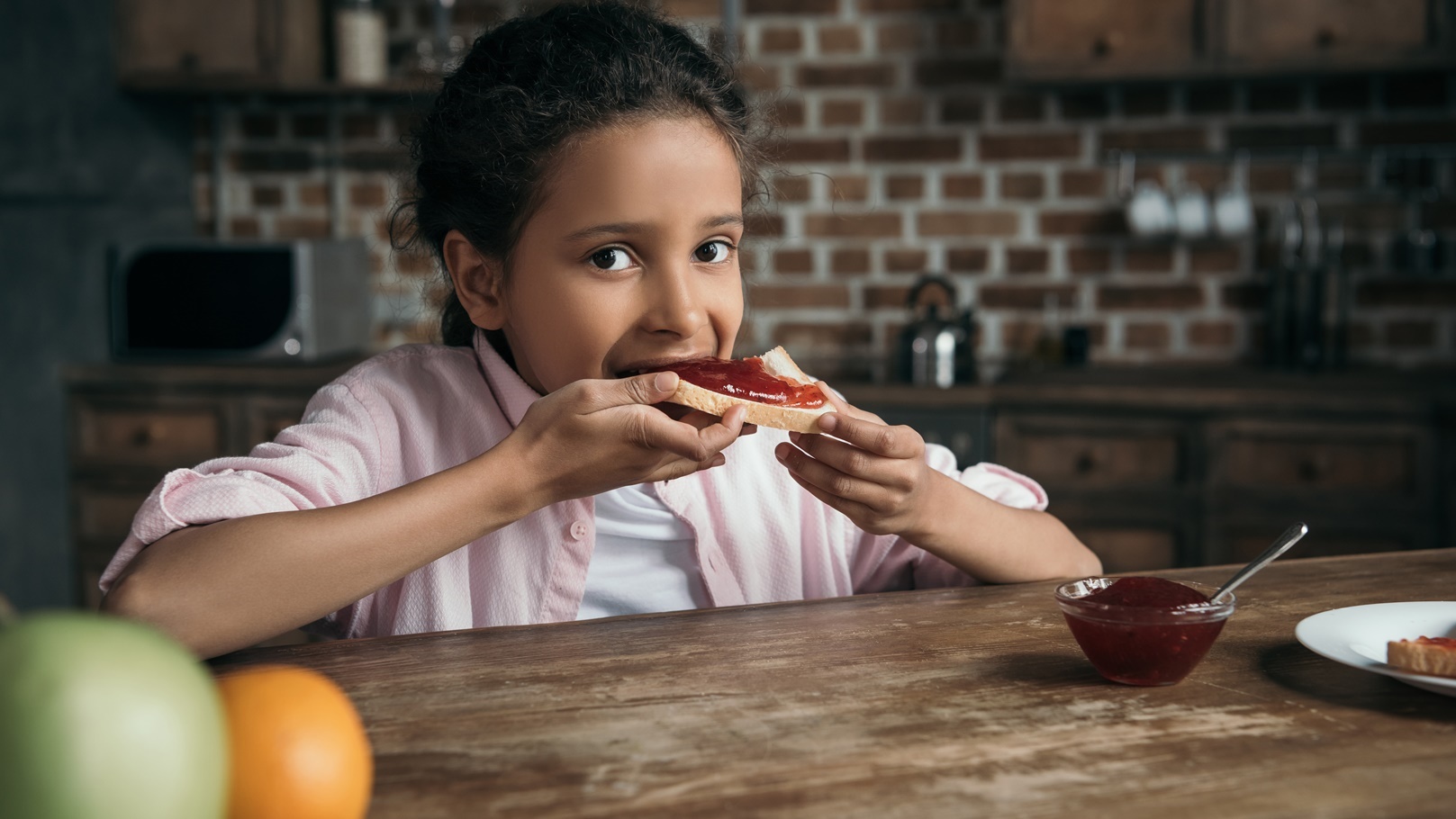little-girl-eating-toast-with-homemade-jam-at-home-2021-09-03-12-15-31-utc