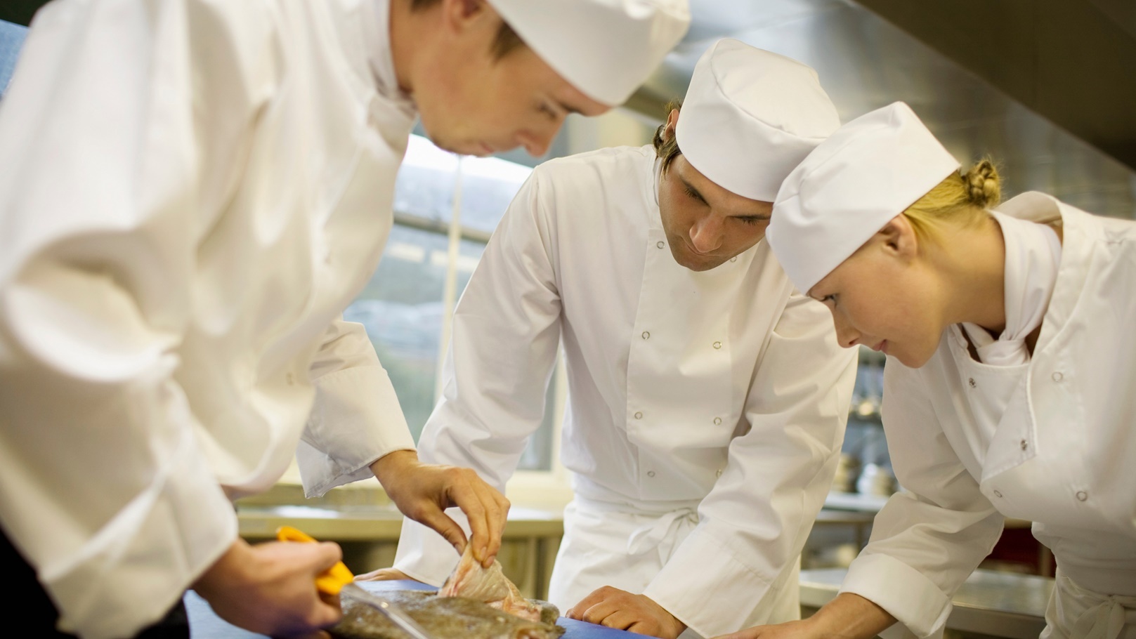 three-chefs-filleting-a-fish-2022-03-04-01-54-38-utc