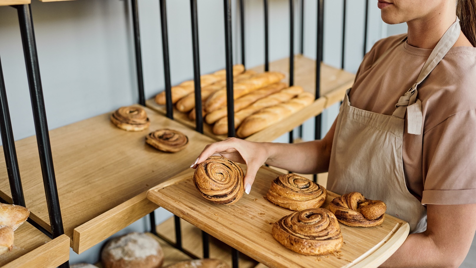 woman-with-tray-in-bakery-2021-09-24-02-46-15-utc