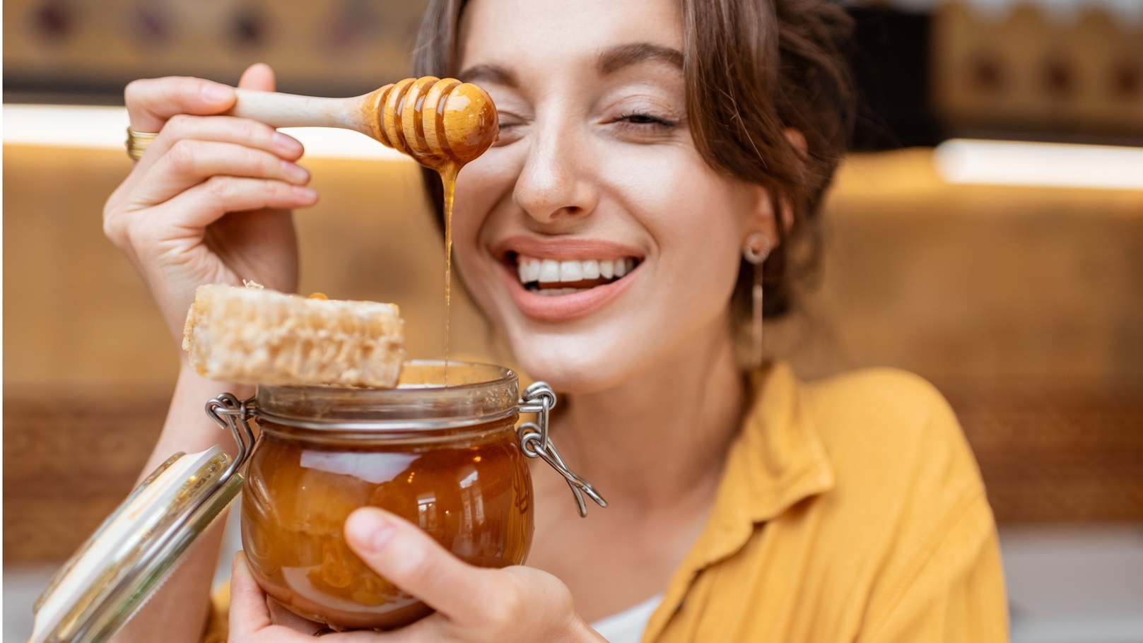 woman-eating-honey-at-home-2021-08-31-08-42-20-utc