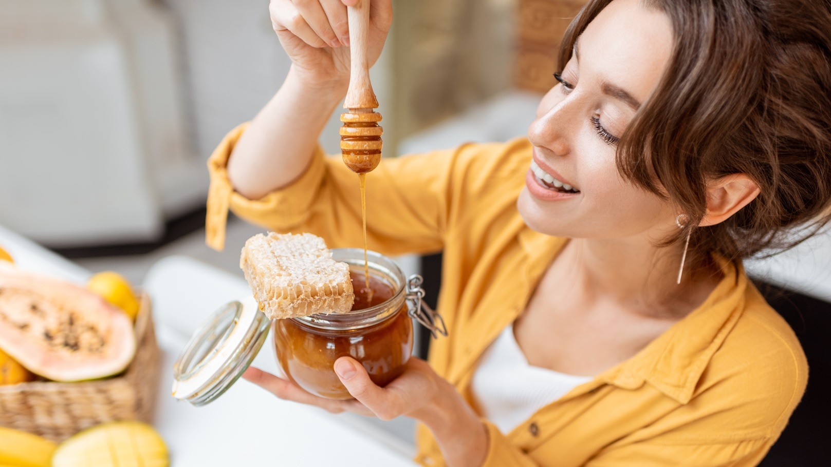 woman-eating-honey-at-home-2021-08-31-08-42-21-utc