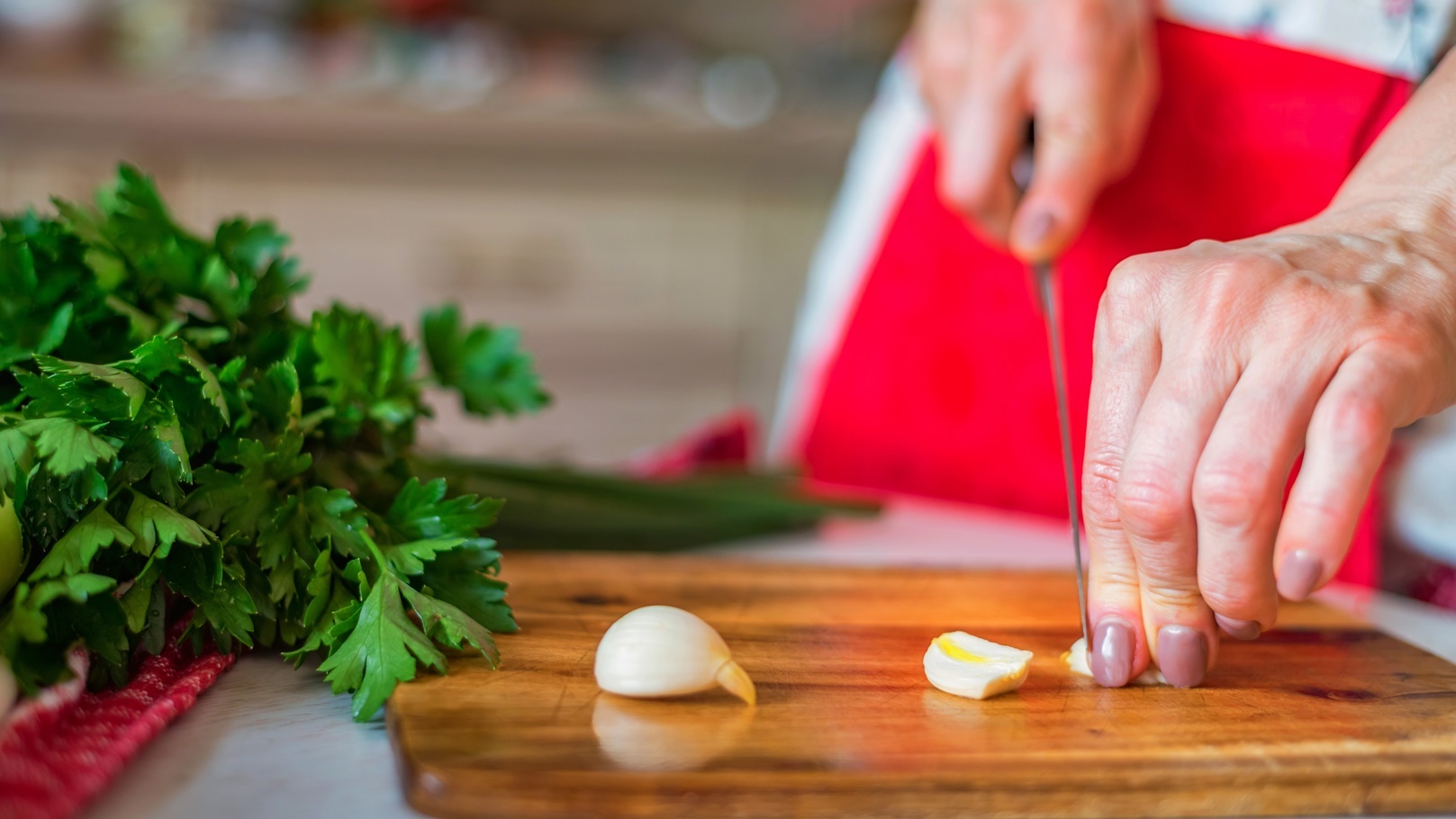 female-hand-with-knife-chops-garlic-in-kitchen-co-2021-08-26-19-57-11-utc