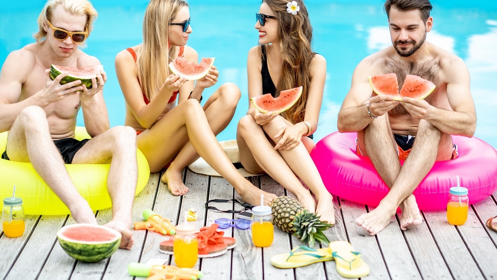 friends-with-watermelon-on-the-swimming-pool-outdo-2022-01-18-23-56-09-utc